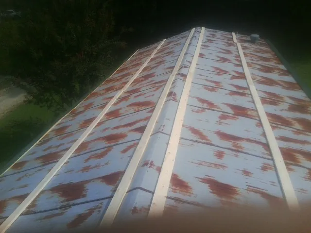 Rusted metal roof panels with new wood purlins before replacement — Storm Damage Roof Repair in El Granada by Roofing Brothers