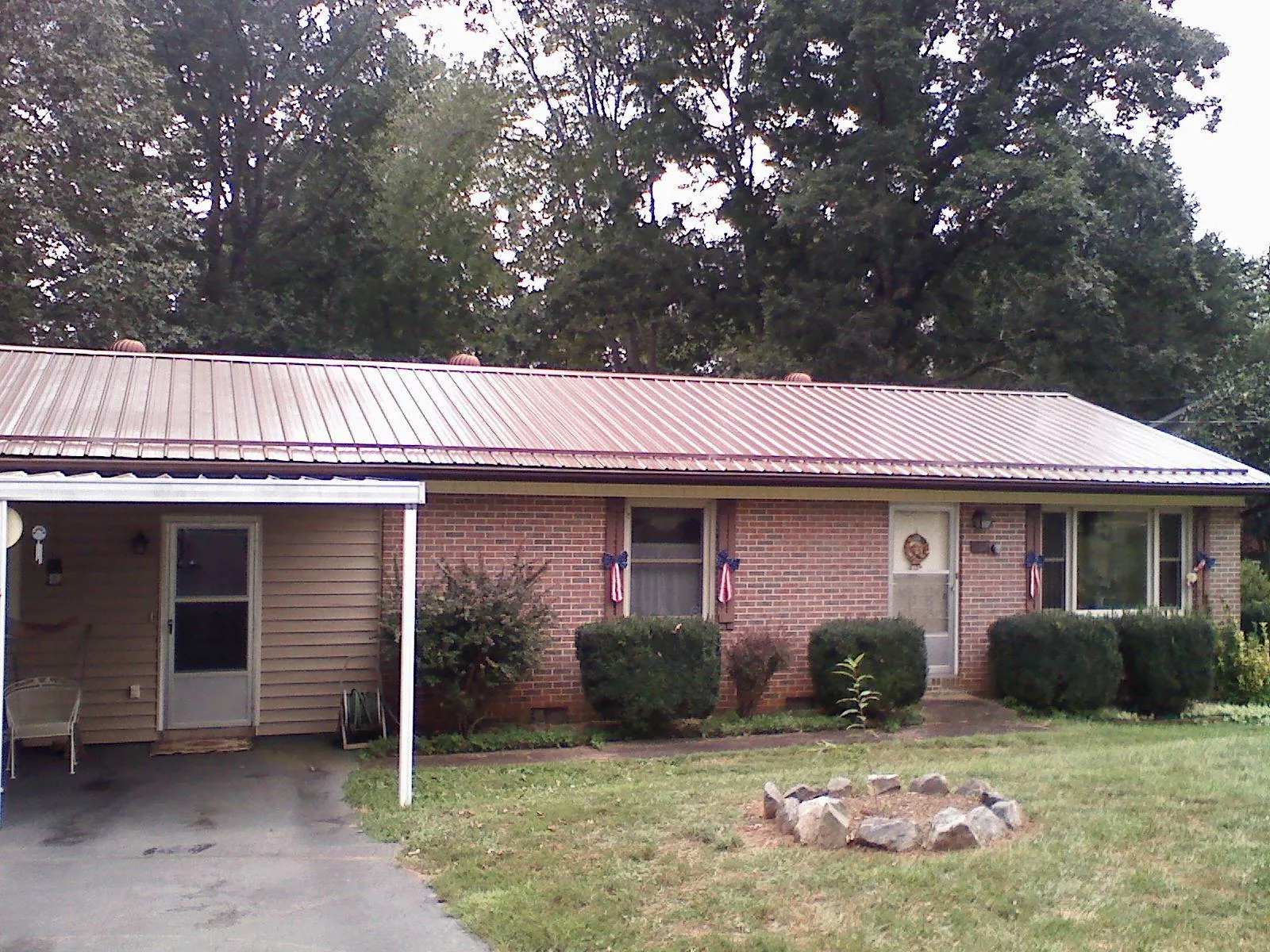 Bronze metal roof and carport on a brick ranch home — Roof Repair work by our crew in El Granada